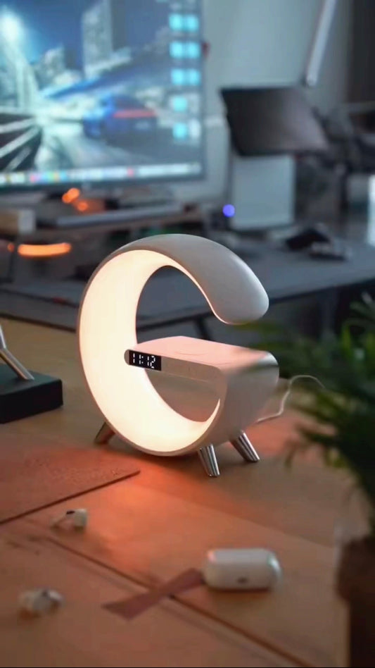 G Shaped LED Lamp on desk with Bluetooth speaker and smart light features.